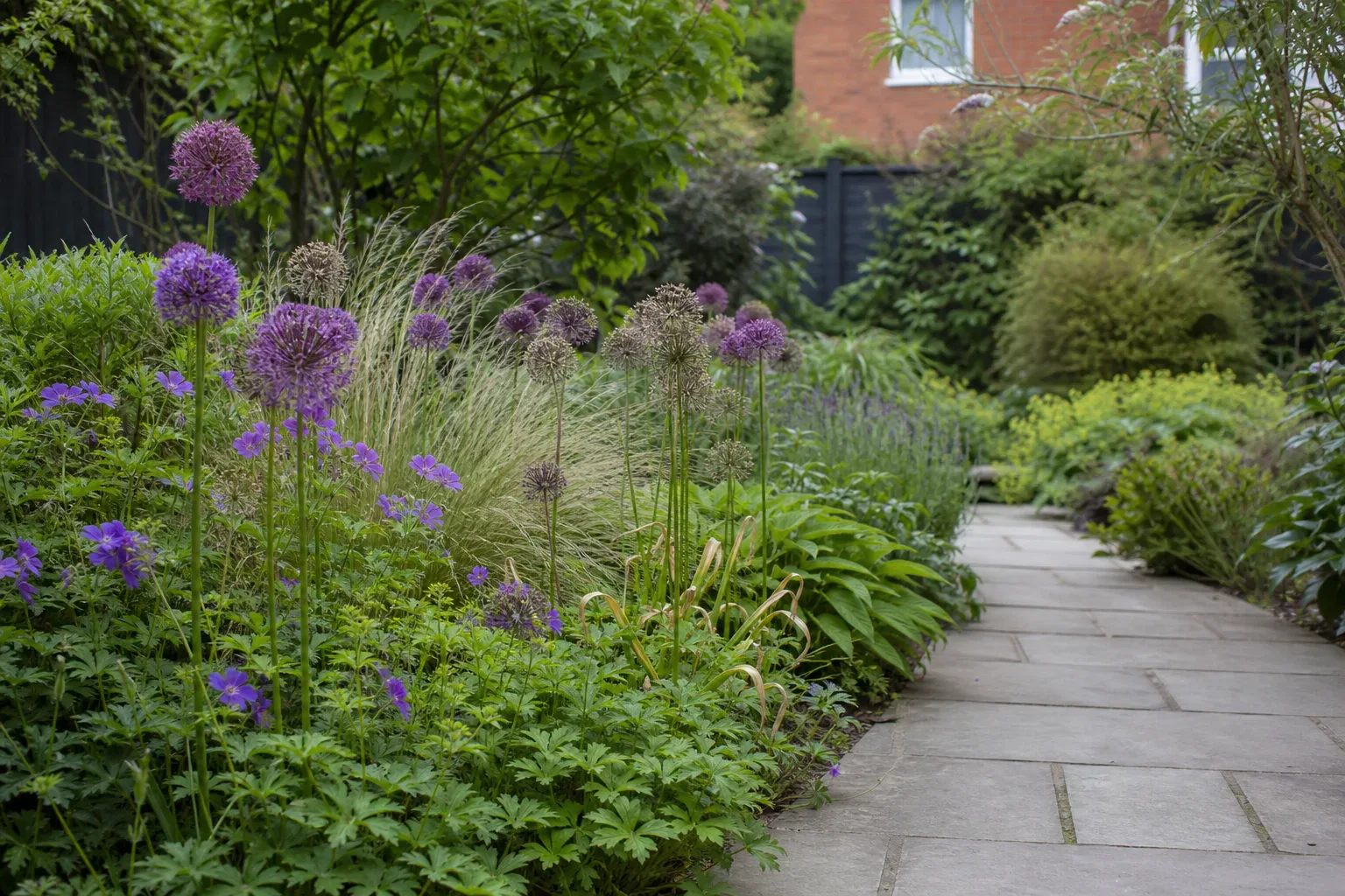 A relaxed planted border beside a UK garden path