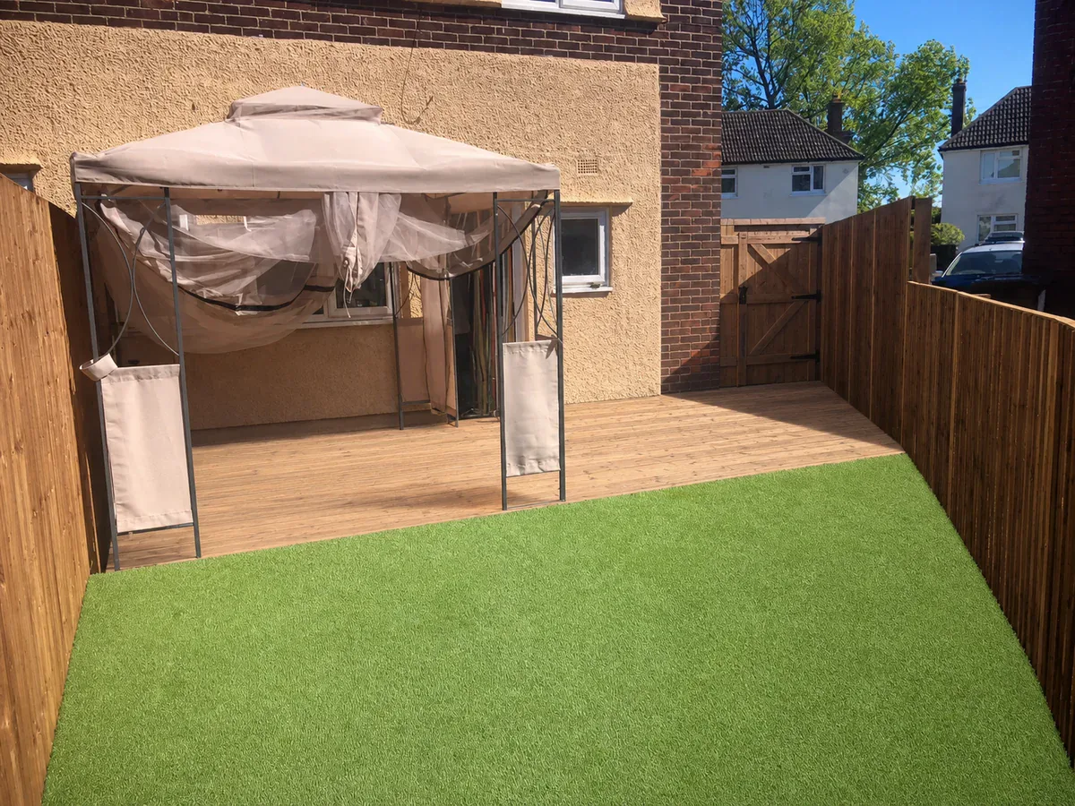Completed garden with timber decking and a low-maintenance lawn