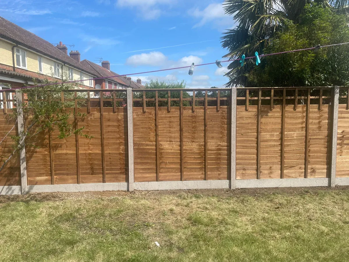 Completed timber garden fence with concrete posts and gravel boards