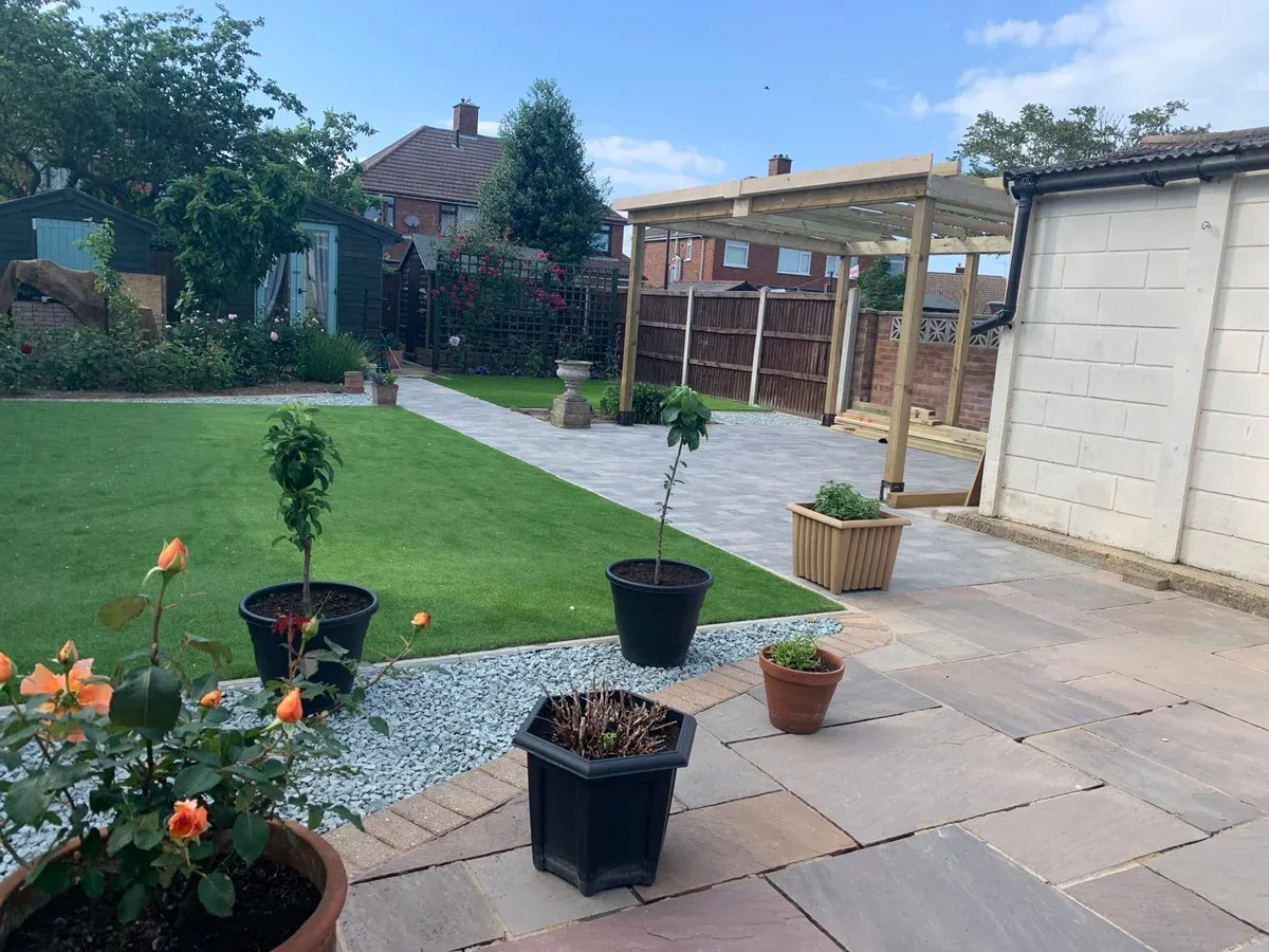 Completed garden layout with lawn, paving and timber structure